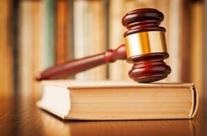 A judge 's gavel on top of an open book.